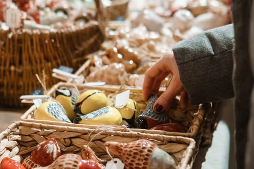 Sale of handmade ceramic Christmas tree toys at the Christmas Fair. Black Friday for the winter holidays