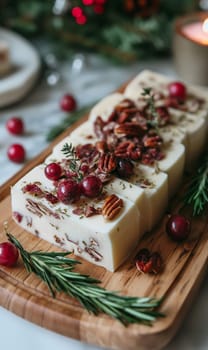 Natural organic glycerin soap with cranberry and pecan slices on a wooden tray, decorated with rosemary