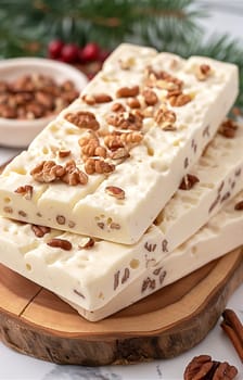 White chocolate bark with pecan nuts on wood slices for a holiday dessert treat