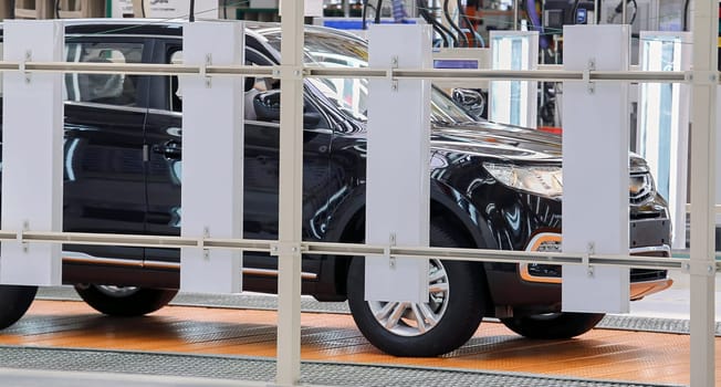 Car manufacturing. The conveyor at the plant has stopped. Unfinished passenger car.