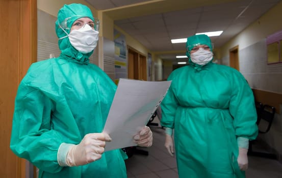 Coronavirus infection, hCov, biohazard, virus, face in protective suit and gas mask.