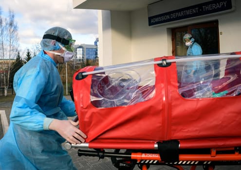 Coronavirus infection, hCov, biohazard, virus, face in protective suit and gas mask.