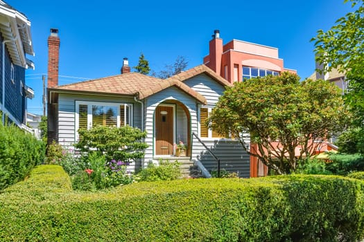 Residential house with green hedge on front yard.