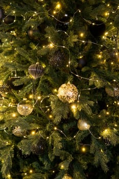 Balls on the Christmas tree close-up. Christmas tree design decorations. The concept of celebrating New Year and Christmas