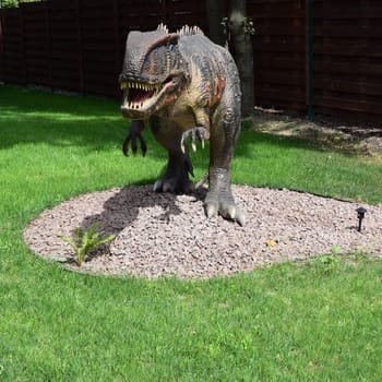 DINO PARK, KHARKOV - AUGUST 8, 2021: Park Museum with historical sculptures of dinosaurs in the open air. The prehistoric animals ever lived on earth million years ago. Small Tyrannosaurus rex