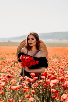 Woman poppies field. portrait of a happy woman with long hair in a poppy field and enjoying the beauty of nature in a warm summer day