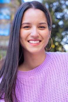 Latin student on campus smiling with headphones looking at camera College life concept.