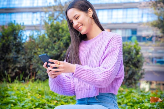 Latin woman hands typing on phone browsing telephone on social media.
