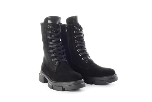 Pair of black suede boots isolated on white background. Product shot for design and print. Footwear fashion and retail concept.