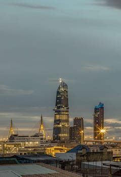 Bangkok, Thailand - Aug 14, 2024 - Night city view with KingBridge tower alongside the iconic landmark of Bhumibol Bridge. Stunning At Twilight skyline of bangkok business district with Skyscrapers use it as your wallpaper, poster and banner design, Selective focus.