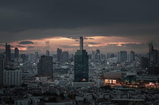 Bangkok, Thailand - 15 Aug 2024 - View of Beautiful Clouds in the Sky over Large Metropolitan City. Bangkok city skyscrapers after sunset with Dramatic sky background before Sunset, Space for text, Selective focus.