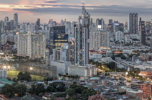 Bangkok, Thailand - 15 Aug 2024 - Bangkok city skyscrapers after sunset with Dramatic sky background before Sunset. View of Beautiful Clouds in the Sky over Large Metropolitan City, Copy space, Selective focus.