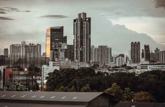 Bangkok, Thailand - 14 Aug, 2024 - Architecture exterior of Modern high-rise buildings of Dramatic sky in the city of Bangkok. Picturesque view of skyscrapers before Sunset, Space for text, Selective focus.
