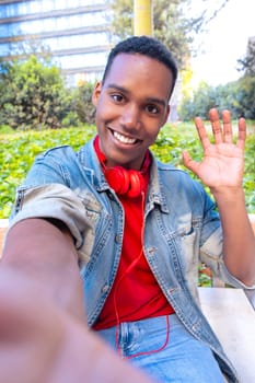 Happy young african american taking a selfie with smartphone.Vertical