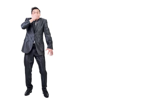 Full body of male loudmouth in formal suit looking at camera while covering mouth isolated on white background in studio