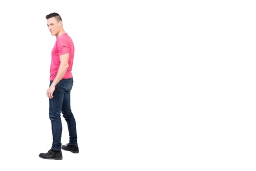Full body side view of masculine male model winking at camera against white background