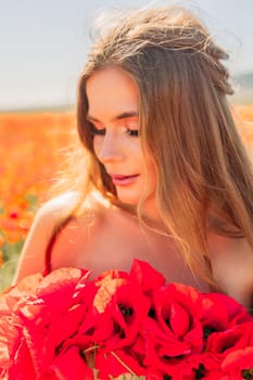 Woman poppies field. portrait of a happy woman with long hair in a poppy field and enjoying the beauty of nature in a warm summer day