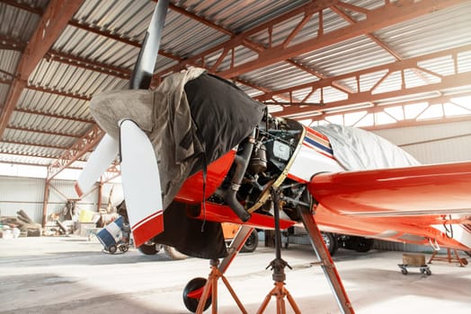 Ultralight small private aircraft airplane on repair in the hangar at the aerodrome airport
