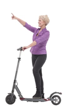in full growth. smiling mature woman with an electric scooter . isolated on a white background.