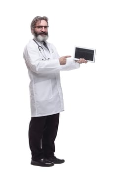 in full growth. man is a doctor pointing at the screen of a digital tablet. isolated on a white