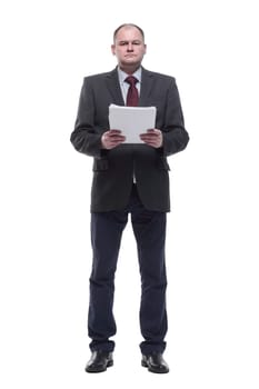 in full growth. business man with a bundle of business documents. isolated on a white background.
