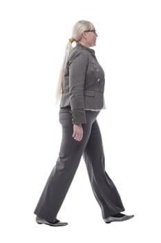 in full growth. successful business woman walking . isolated on a white background
