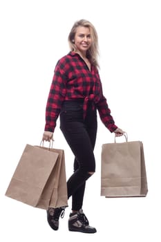 in full growth. cheerful young woman with shopping bags . isolated on a white background.