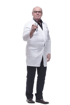 in full growth. smiling doctor pointing at you. isolated on a white background