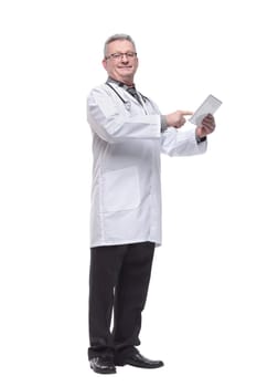 Senior doctor wearing tie and glasses using his tablet computer at work