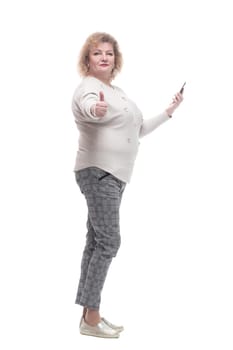 in full growth. attractive adult woman with a smartphone. isolated on a white background.