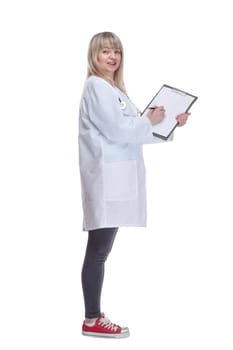 side view. young female doctor making notes in a clipboard . isolated on a white background.