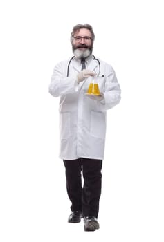 in full growth. doctor with a laboratory flask striding forward . isolated on a white background