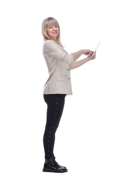 side view. attractive blonde woman using her digital tablet . isolated on a white background.