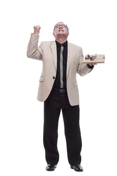 in full growth. Mature intelligent man with a gift box. isolated on a white background.