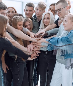 close up. a group of young people showing their unity. the concept of teamwork