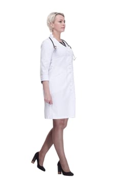 in full growth. confident female doctor stepping forward . isolated on a white background.