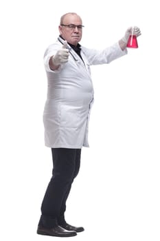 side view. doctor therapist looking at a flask of liquid . isolated on a white background
