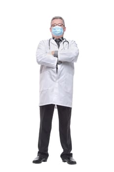 Portrait of a handsome doctor with stethoscope standing confidently and wearing mask, isolated on white background