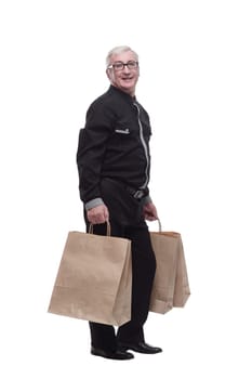 in full growth. happy casual man with shopping bags. isolated on a white background.