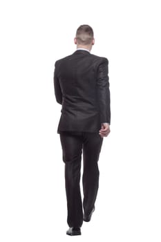 in full growth. young businessman confidently striding forward. isolated on a white background.