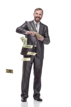in full growth. happy business man with dollar bills. isolated on a white background.