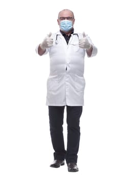in full growth. a serious doctor in a protective mask . isolated on a white background