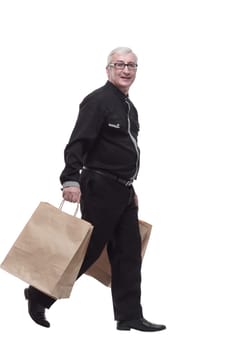 casual man with shopping bags striding forward. isolated on a white background.