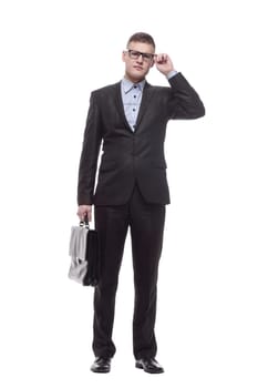 in full growth. responsible young businessman with a smartphone. isolated on a white background.