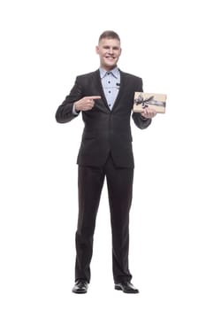 in full growth. happy young businessman with a gift box . isolated on a white background.