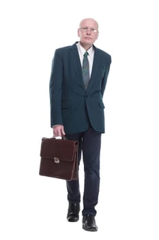 side view. confident business man with a briefcase looking at you. isolated on a white background.
