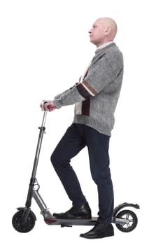 side view. mature man with electric scooter looking at you. isolated on a white background.