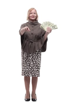 in full growth. happy mature woman with dollar bills . isolated on a white background.