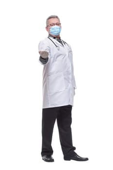 Portrait of a doctor in mask and gloves pointed at camera isolated on white background