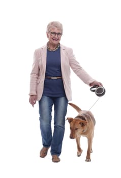 side view . senior lady and her dog walking together. isolated on a white background